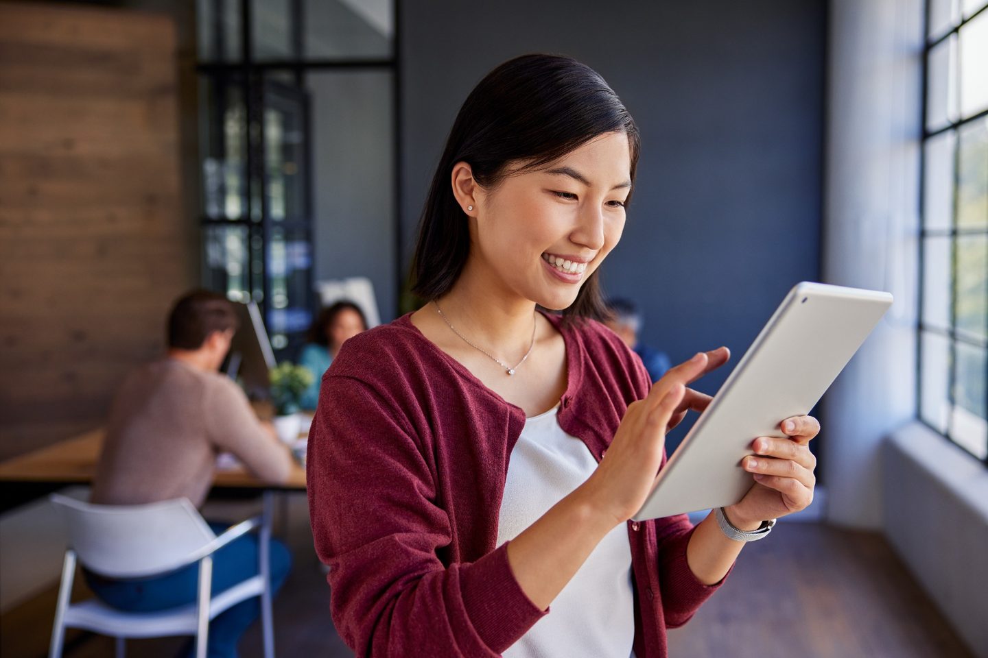 Professional reviewing work information on a tablet